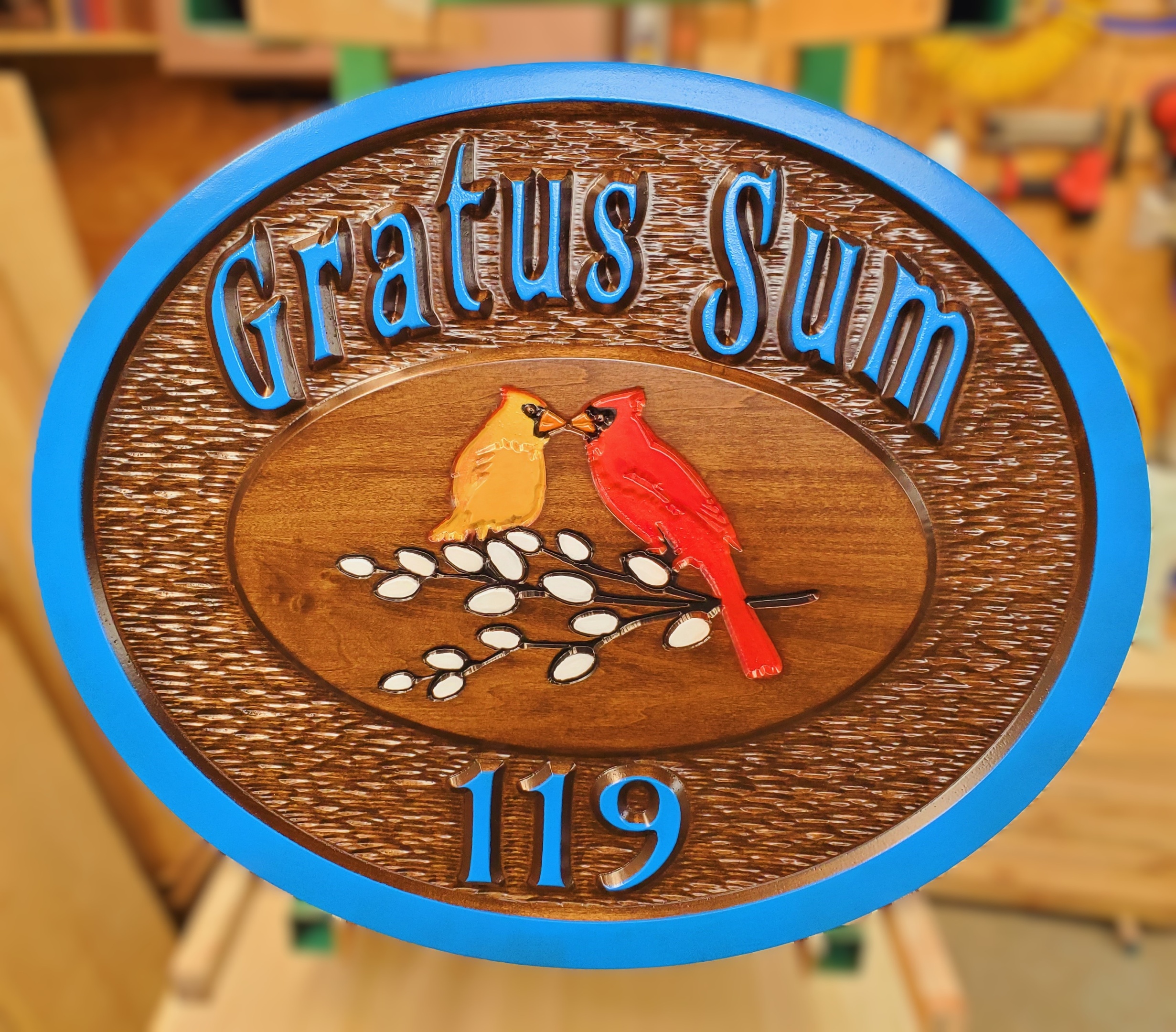stained and painted sign with Northern cardinal