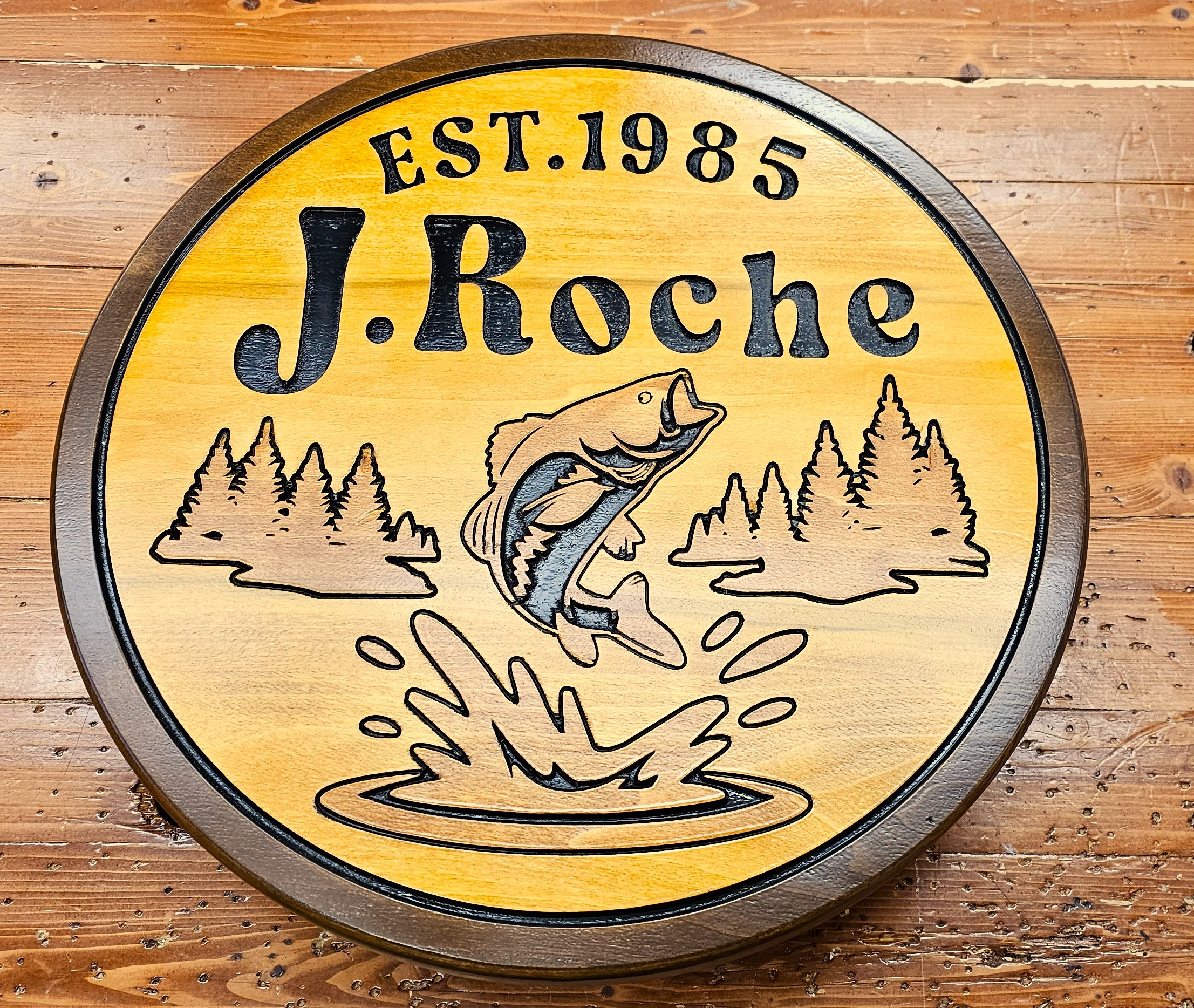 Cottage sign with fish and pine trees